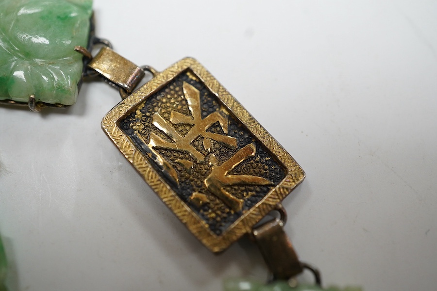 A Chinese gilt white metal and carved jade panel set bracelet, a.f, 17.5cm, together with a carved jade pendant, 40mm. Condition - poor to fair